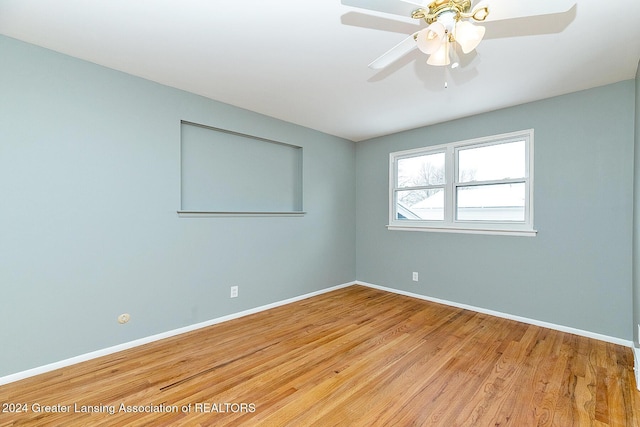 spare room featuring ceiling fan and light hardwood / wood-style flooring