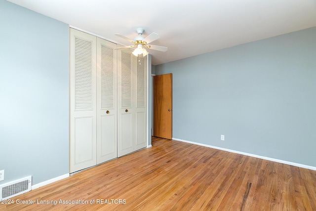 unfurnished bedroom with a closet, ceiling fan, and light hardwood / wood-style floors