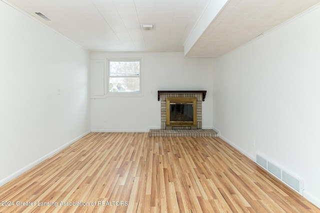 unfurnished living room with a fireplace and light wood-type flooring