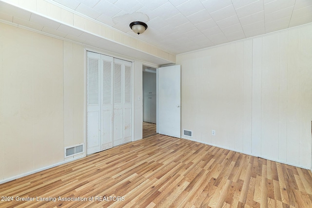 unfurnished bedroom featuring a closet and light hardwood / wood-style flooring