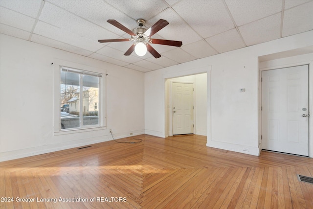 unfurnished room featuring a paneled ceiling and ceiling fan