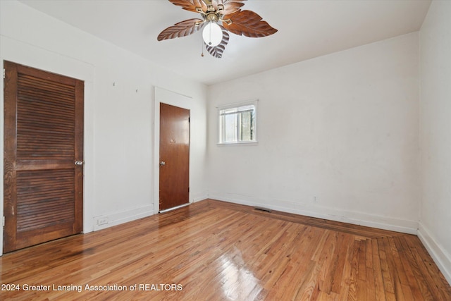 empty room with ceiling fan and light wood-type flooring