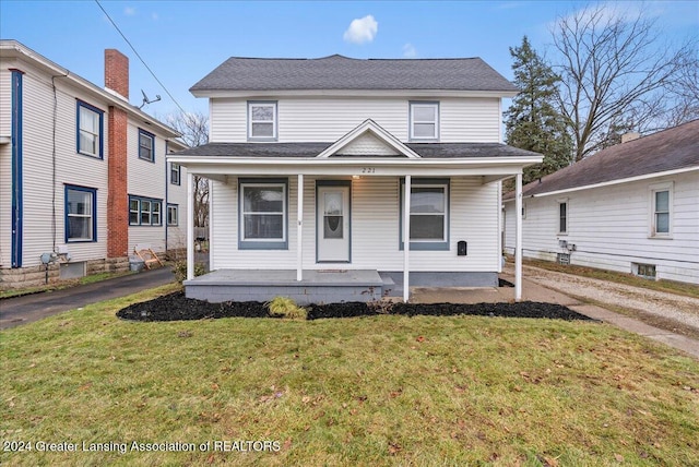 view of front of home with covered porch and a front lawn