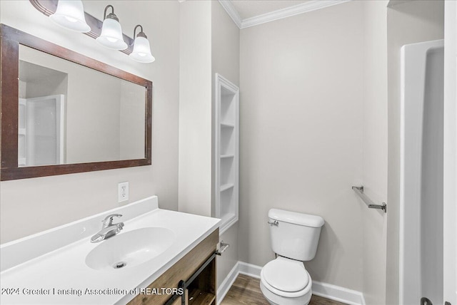 bathroom featuring hardwood / wood-style flooring, vanity, toilet, and ornamental molding