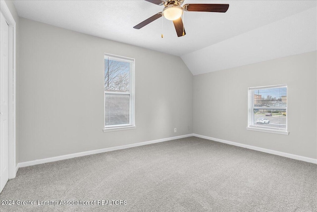 additional living space featuring ceiling fan, lofted ceiling, and carpet floors