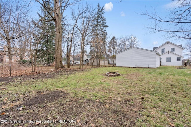 view of yard with a fire pit