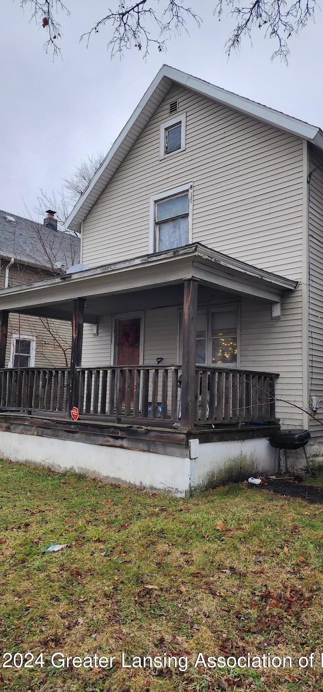 rear view of property with a yard