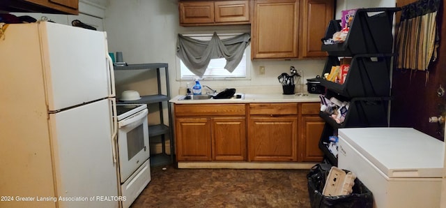 kitchen featuring range, sink, and white refrigerator