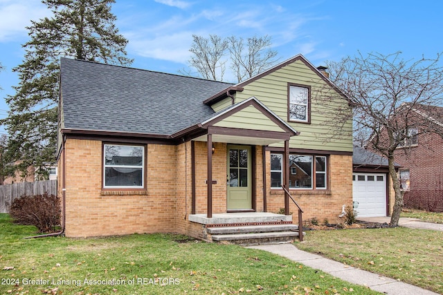 view of property with a garage and a front yard