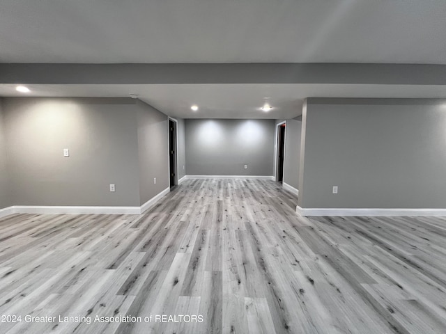 basement with light hardwood / wood-style flooring