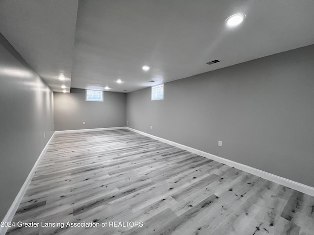 basement with light hardwood / wood-style flooring