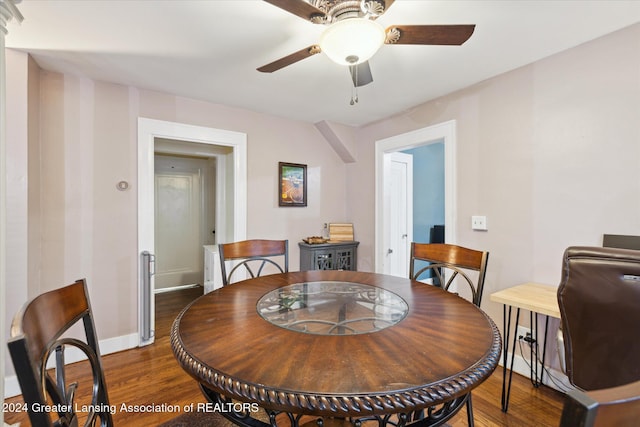 dining room with ceiling fan and dark hardwood / wood-style floors