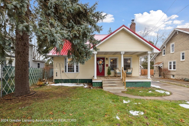 bungalow-style house with a front yard and a porch