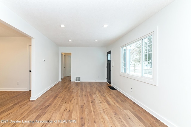 unfurnished room with light wood-type flooring