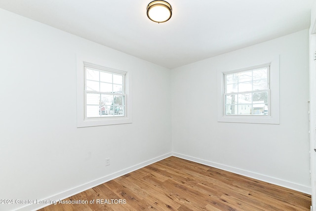 unfurnished room with hardwood / wood-style floors