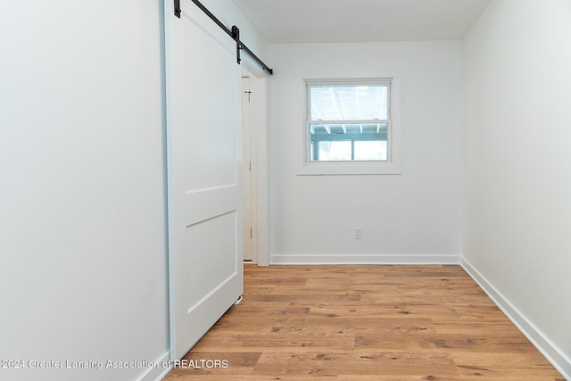 interior space featuring a barn door and light hardwood / wood-style floors