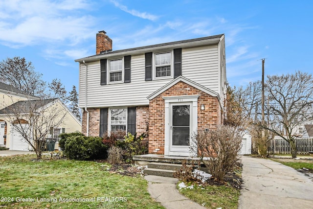 view of front property with a garage and a front yard