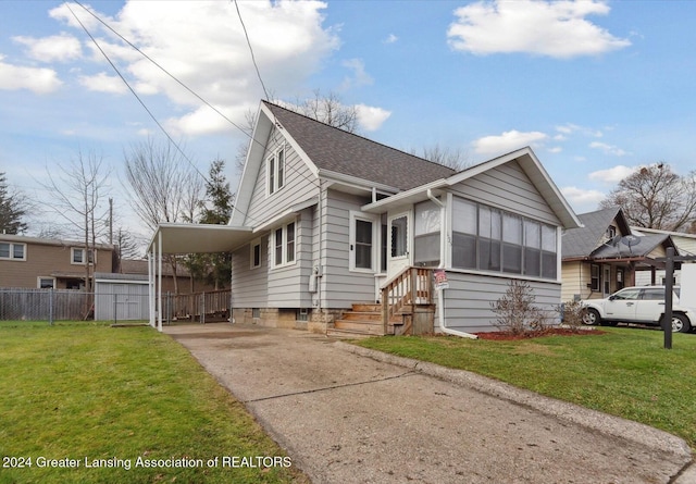 view of front of house with a front lawn and a carport