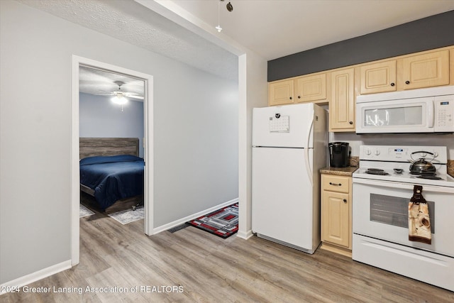 kitchen featuring a textured ceiling, ceiling fan, light hardwood / wood-style flooring, and white appliances