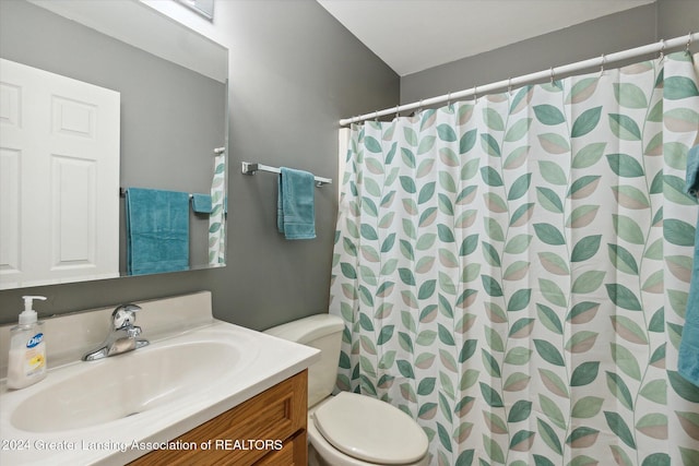 bathroom featuring a shower with curtain, vanity, and toilet