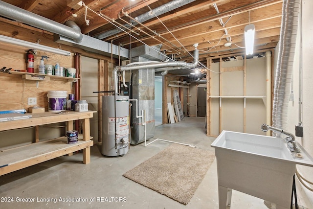 basement with gas water heater, heating unit, and sink