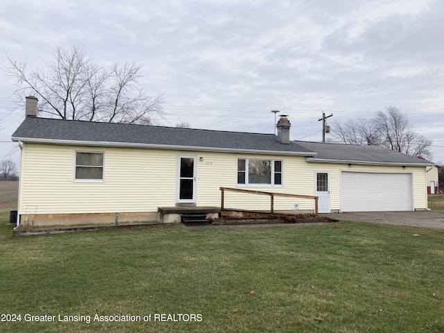 view of front of home featuring a garage and a front lawn