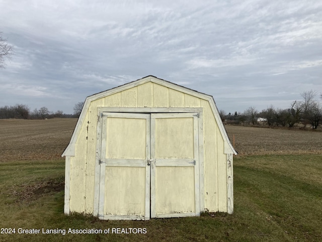 view of outbuilding with a yard