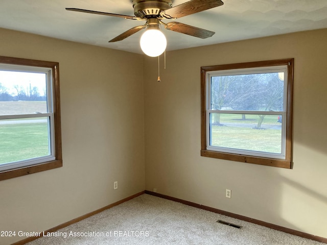 empty room featuring carpet flooring and ceiling fan