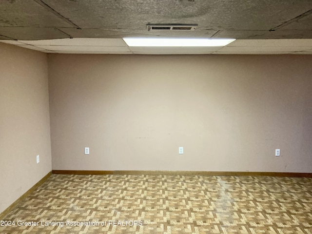 unfurnished room with a paneled ceiling