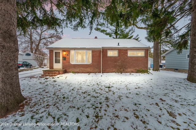 view of snow covered rear of property