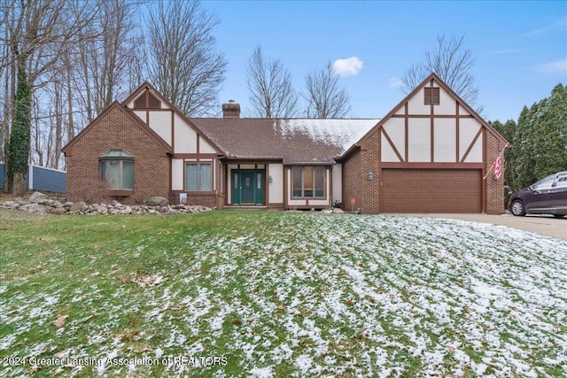 tudor house with a lawn and a garage