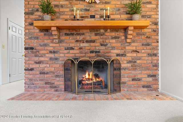 details featuring carpet flooring and a brick fireplace