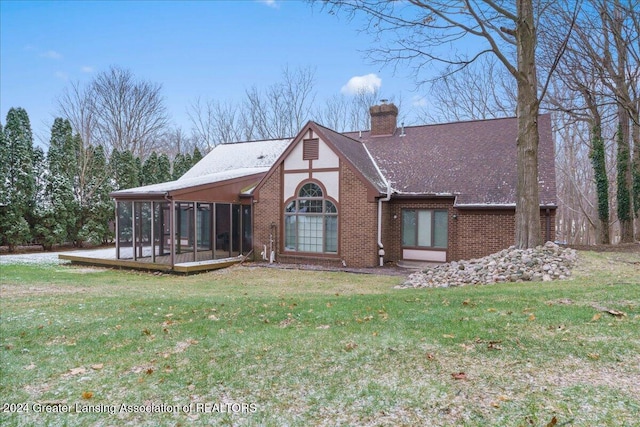 back of house with a sunroom and a yard