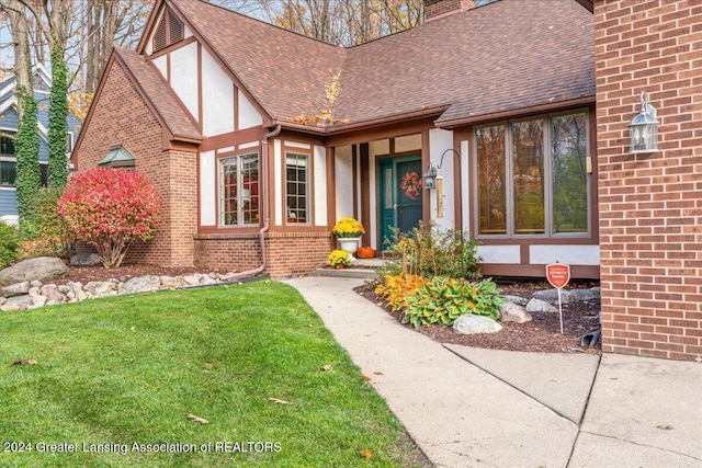 doorway to property featuring a lawn