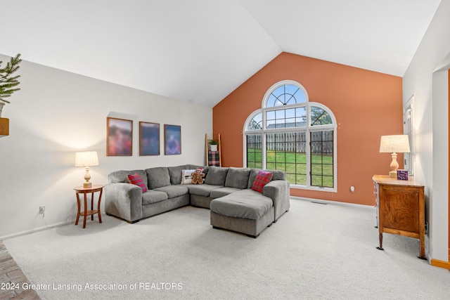 living room featuring carpet flooring and lofted ceiling