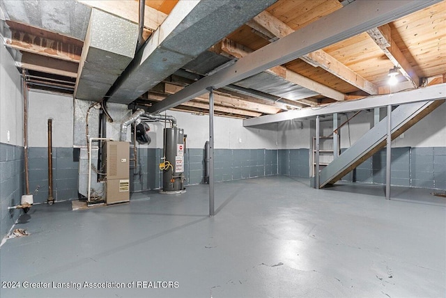 basement featuring heating unit and water heater