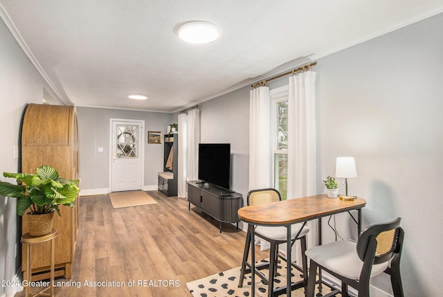 living room featuring crown molding and light wood-type flooring