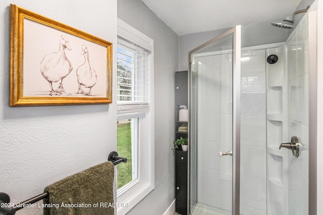 bathroom featuring a shower with door