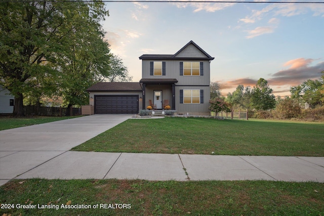 view of front of home featuring a garage and a lawn