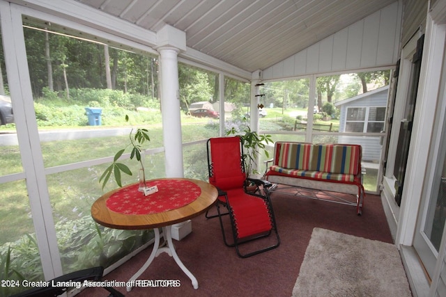 sunroom / solarium featuring vaulted ceiling