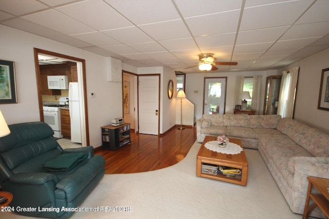 living room featuring hardwood / wood-style floors and ceiling fan