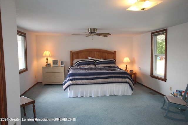 bedroom with ceiling fan and light colored carpet