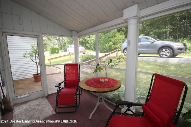 sunroom with lofted ceiling and wood ceiling