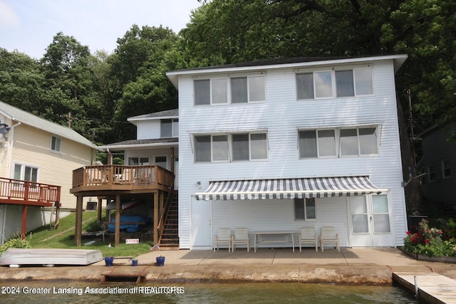 rear view of house with a patio and a wooden deck