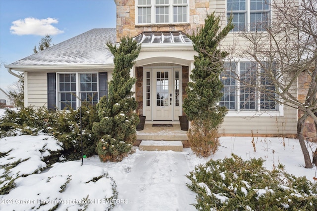 view of snow covered property entrance