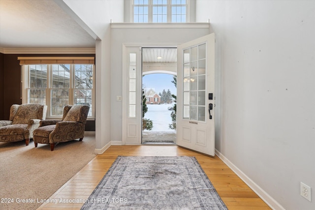 foyer entrance featuring light wood-type flooring and ornamental molding