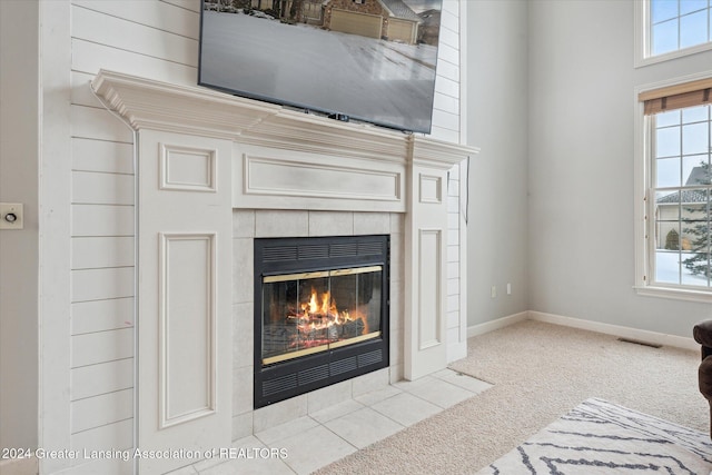 details featuring carpet flooring and a tiled fireplace