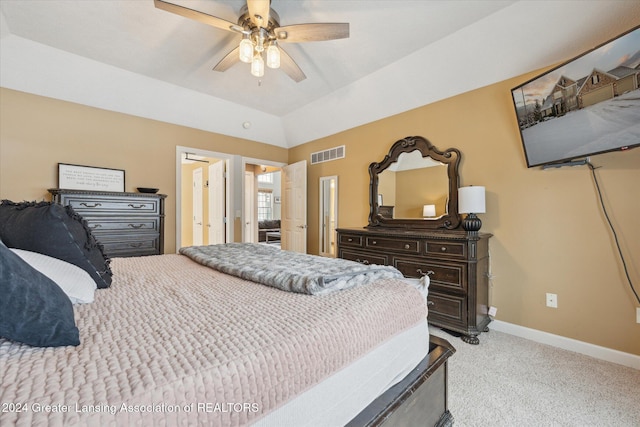 bedroom with ceiling fan, light carpet, and vaulted ceiling