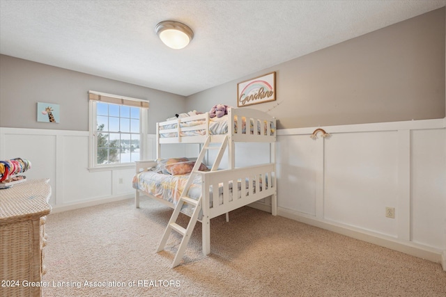 carpeted bedroom with a textured ceiling