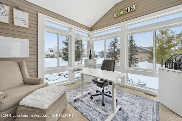 carpeted home office featuring lofted ceiling